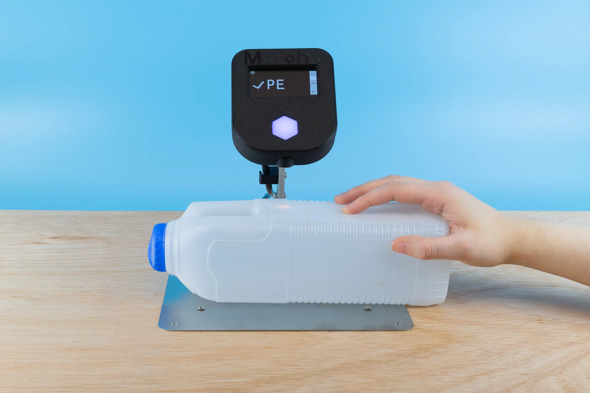 PlasTell bench unit scanning an HDPE milk bottle