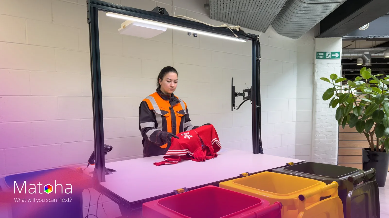 Operator scanning garment on S-Bench station